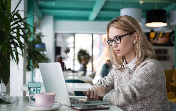 Busy female student preparing for exam in cafe CANADIAN VISA PROFESSIONALS